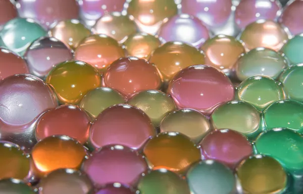Background with transparent colored beads closeup — Stock Photo, Image