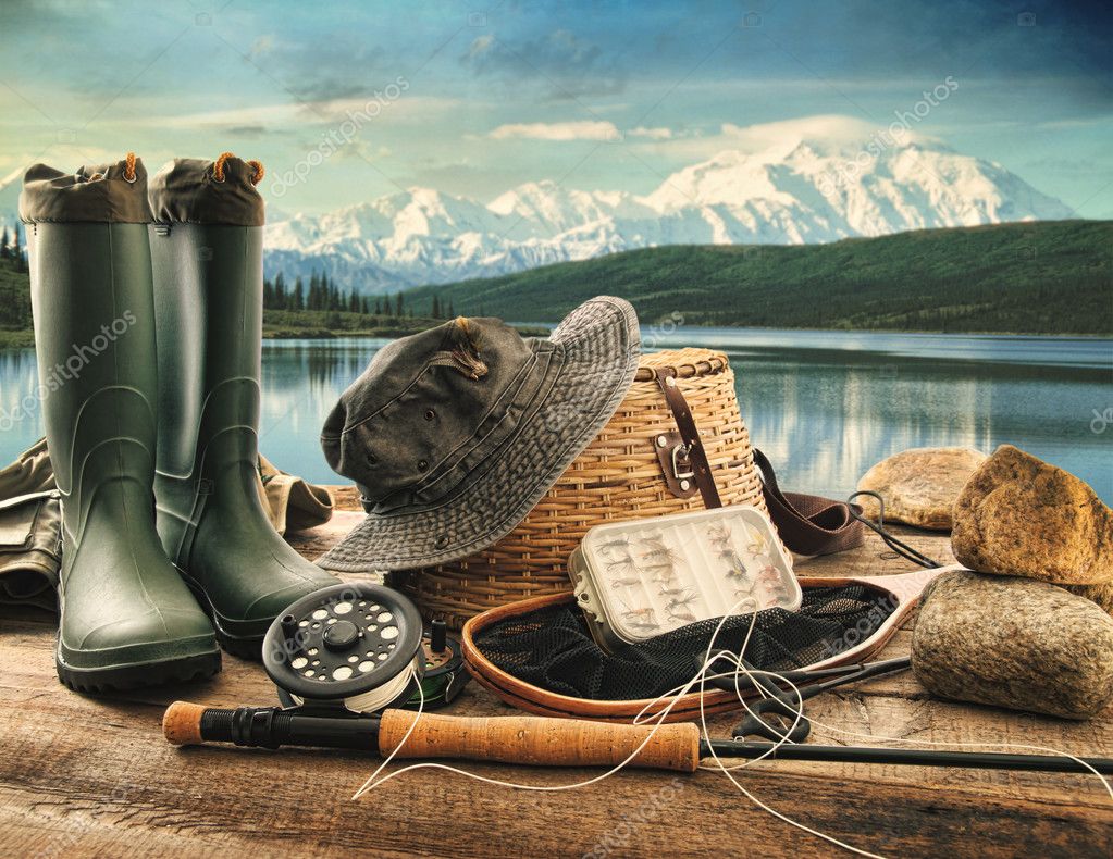 Fly fishing equipment on deck with view of a lake and mountains — Stock  Photo © Sandralise #12020724