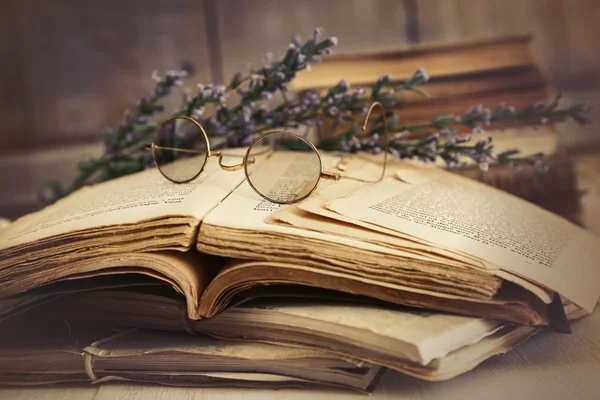 Old books open on wooden table — Stock Photo, Image