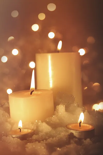 Burning candles in snow — Stock Photo, Image