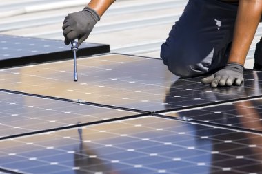 Workers set photovoltaic panels