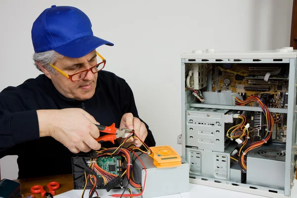 Senior electrician repairing processor — Stock Photo, Image