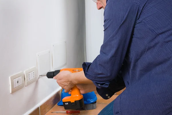 Electrician sets the socket — Stock Photo, Image