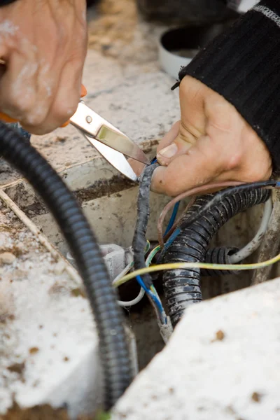 Electrician checks external electrical cable — Stock Photo, Image
