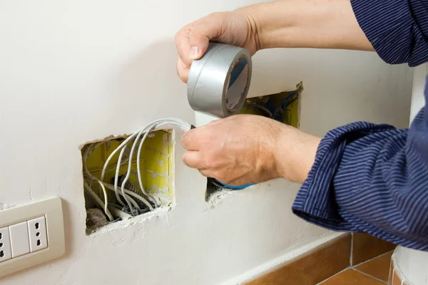 Electrician sets the socket — Stock Photo, Image