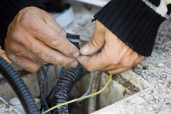 Electrician checks external electrical cable — Stock Photo, Image