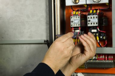 Senior electrician check the electrical panel