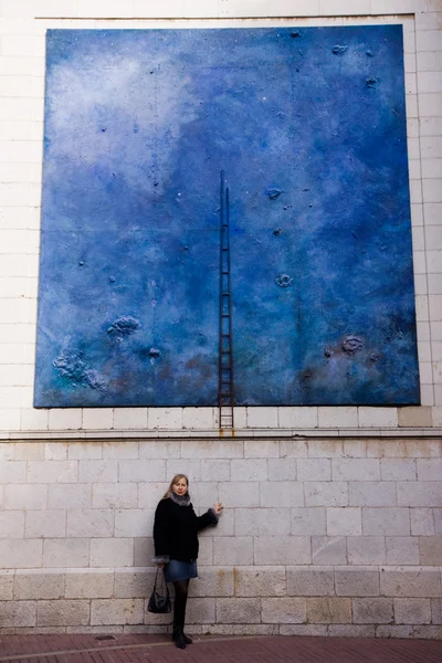 Woman near picture on the wall — Stock Photo, Image