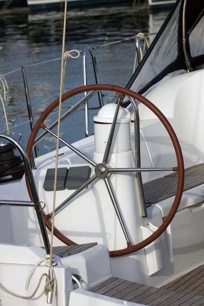 Wheel on the board of boat — Stock Photo, Image