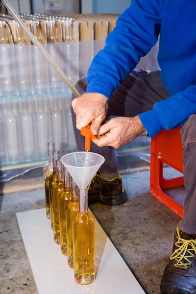 Craftsman filling bottles — Stock Photo, Image