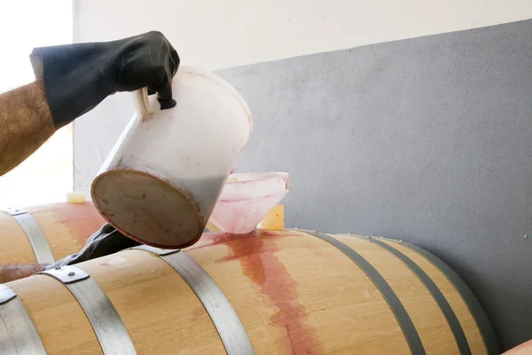 Pouring wine in barrel — Stock Photo, Image