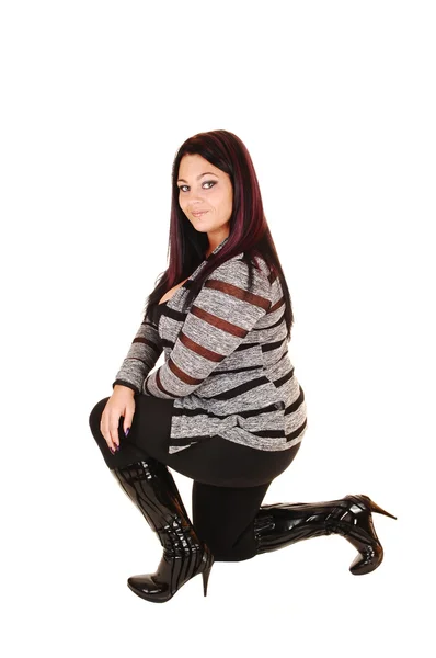 Girl in boots kneeling. — Stock Photo, Image