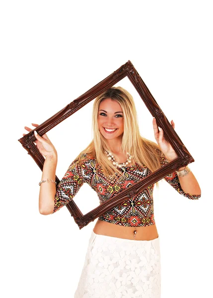 Girl looking trough picture frame. — Stock Photo, Image