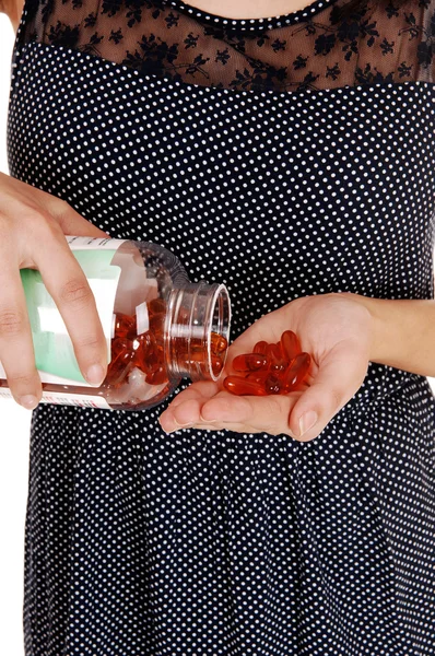 Woman pouring vitamin pills. — Stock Photo, Image