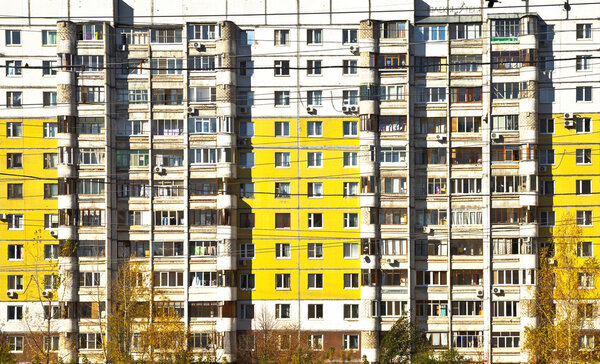 Social facade of an apartment building. Different balconies and yellow panels. Sleeping areas of Samara.