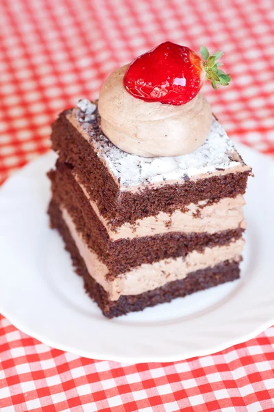 Beautiful cake with strawberry on plaid fabric — Stock Photo, Image