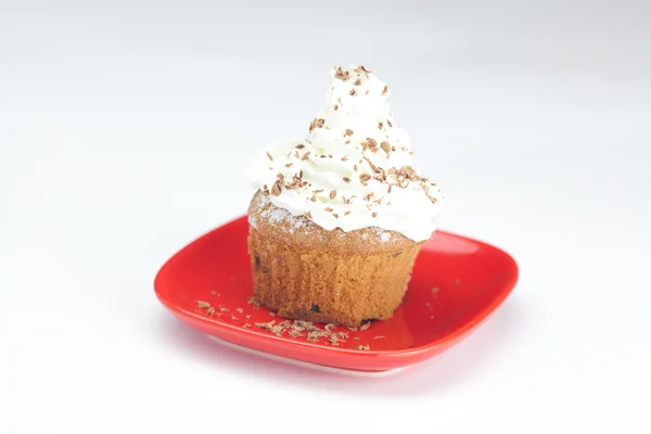 Muffin with whipped cream and nuts — Stock Photo, Image