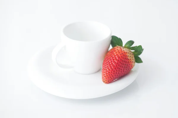 White cup with saucer and strawberries — Stock Photo, Image