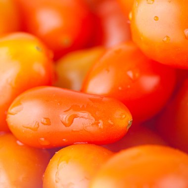 cherry tomatos in bowl on checkered fabric