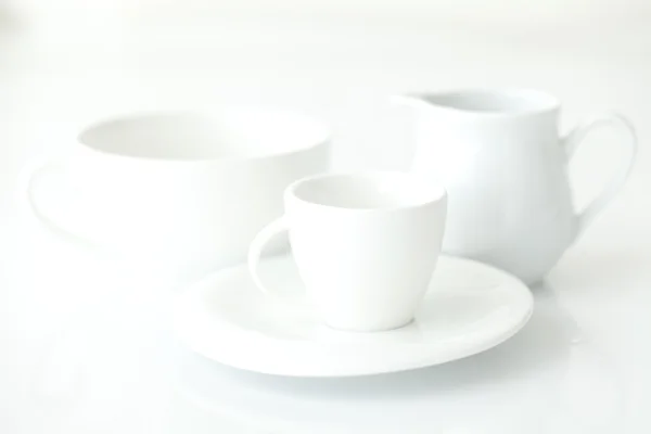 White cup with saucer and milk jug — Stock Photo, Image