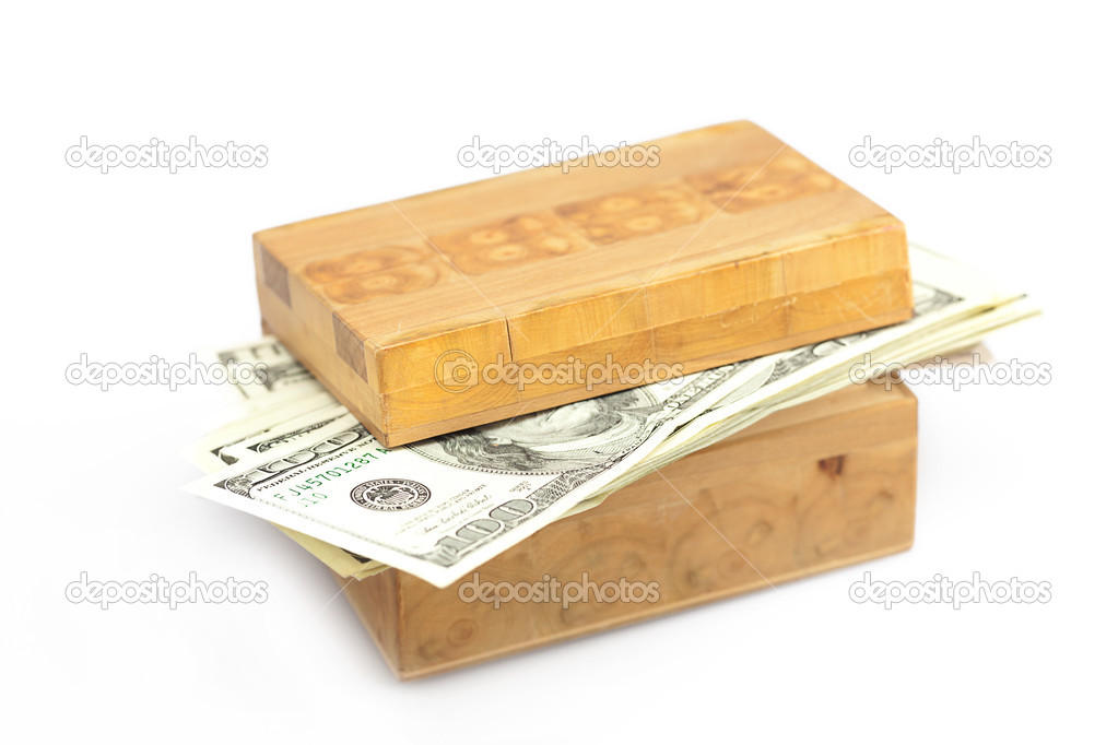 Dollars in the wooden box isolated on white