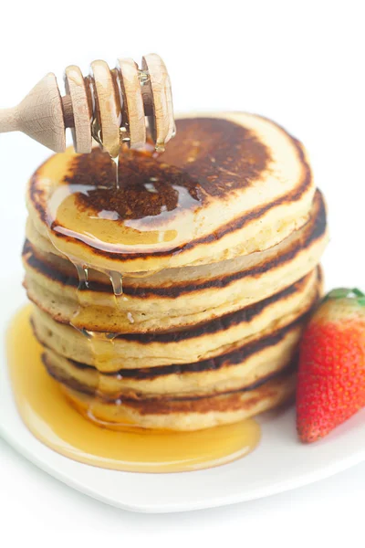 Pancakes, honey, strawberry and stick to honey isolated on white — Stock Photo, Image