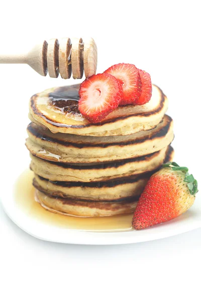 Pancakes, honey, strawberry and stick to honey isolated on white — Stock Photo, Image