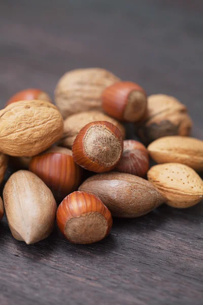 Heap of nuts on a wooden surface — Stock Photo, Image