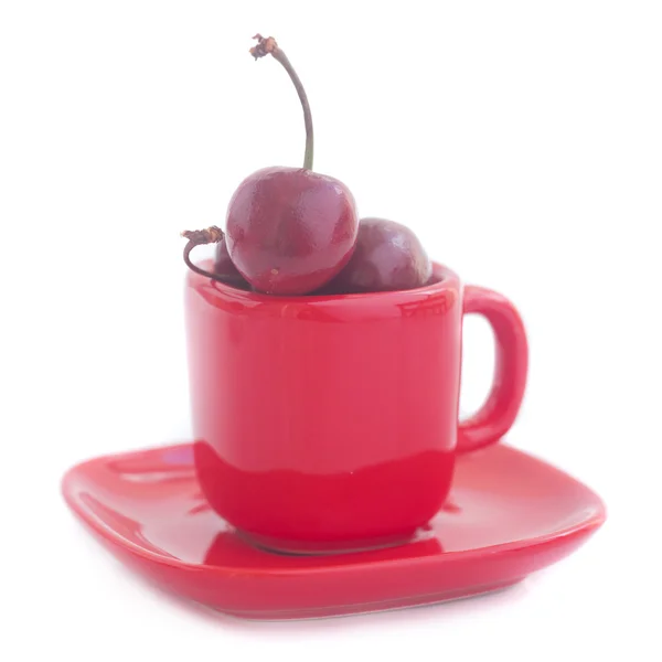 Cherries in red cup isolated on white — Stock Photo, Image