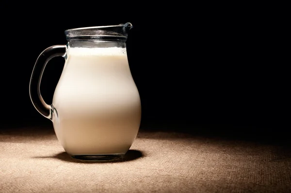 Krug Milch auf Jute — Stockfoto