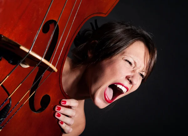 Girl face screaming by double bass — Stock Photo, Image