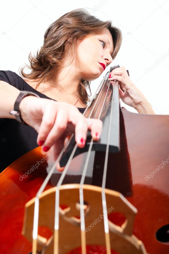 Woman in black dress play double bass. Low point view