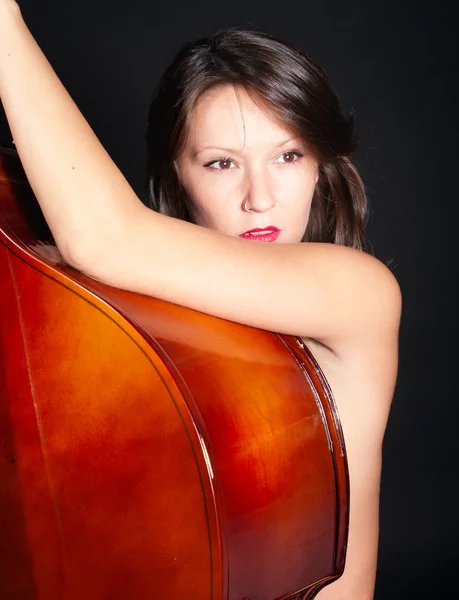 Young woman naked by double bass — Stock Photo, Image