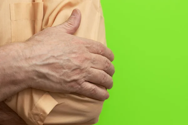 Menselijke hand op groene achtergrond — Stockfoto