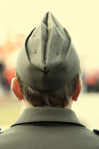 Young soldier in field cap focusing point on back of the head — Stock Photo, Image