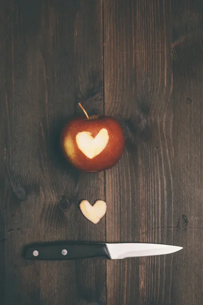 Apple with a heart cut into it — Stock Photo, Image