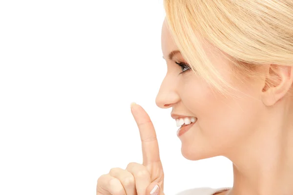 Mujer feliz con el dedo en los labios —  Fotos de Stock