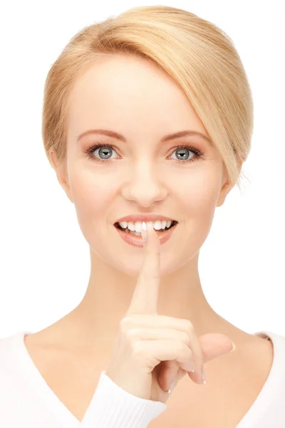 Happy woman with finger on lips — Stock Photo, Image