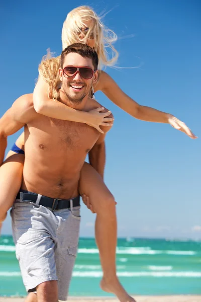 Happy couple in sunglasses on the beach Stock Image