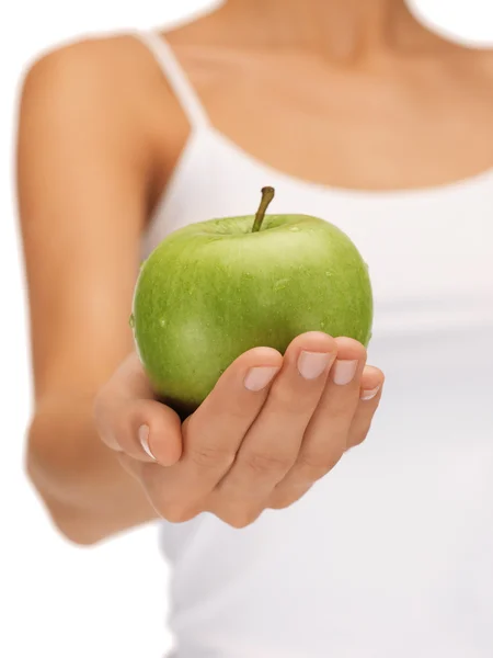 Mains féminines avec pomme verte — Photo