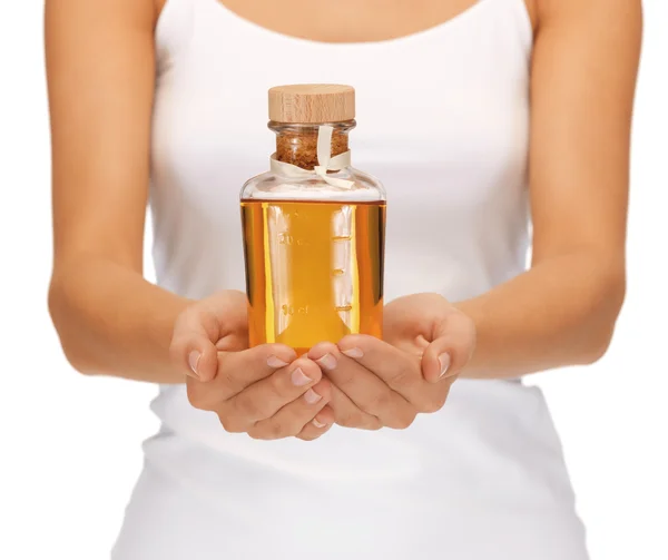 Manos femeninas con botella de aceite —  Fotos de Stock