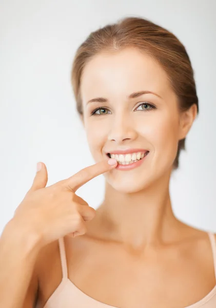 Mulher bonita apontando para os dentes — Fotografia de Stock