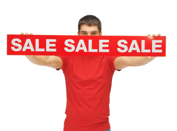 Homem segurando sinal de venda — Fotografia de Stock