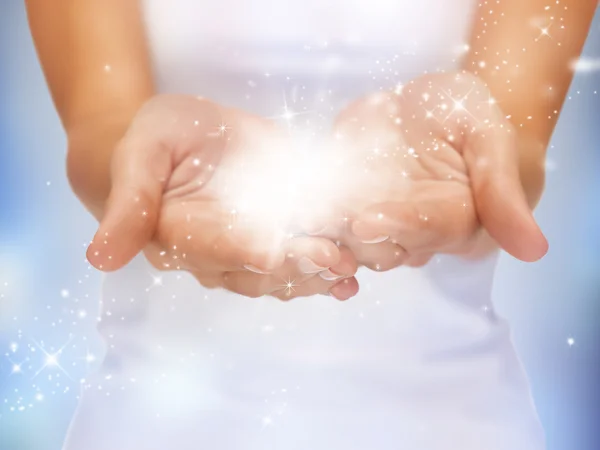 Magic twinkles on female hands — Stock Photo, Image