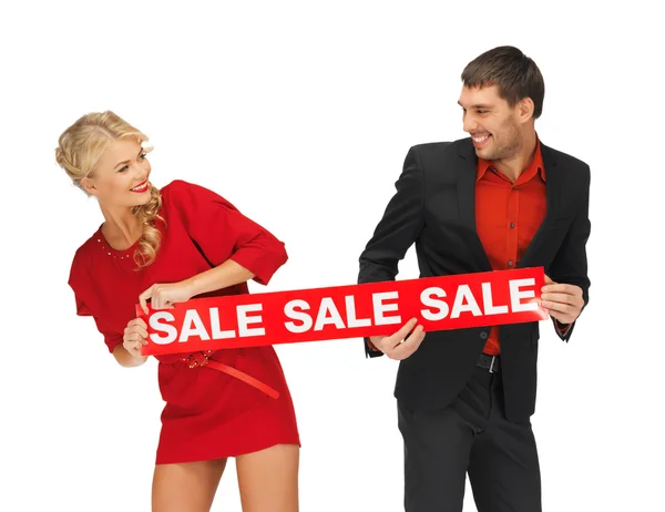 Uomo e donna con segno di vendita — Foto Stock