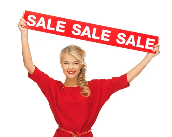 Härlig kvinna i röd klänning med försäljning tecken — Stockfoto