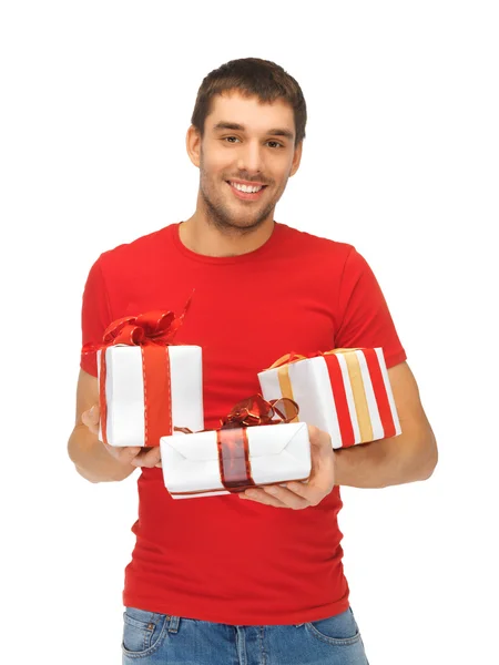 Homem segurando muitas caixas de presente — Fotografia de Stock