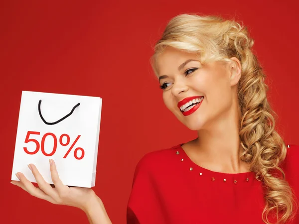 Lovely woman in red dress with shopping bag — Stock Photo, Image