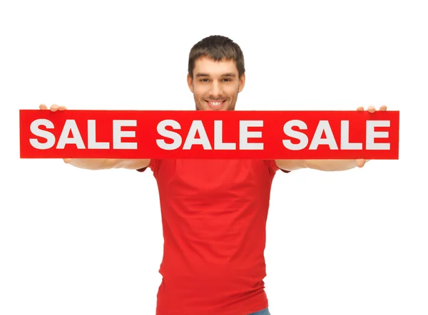 Handsome man with sale sign — Stock Photo, Image