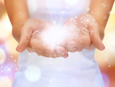 Magic twinkles on female hands clipart